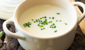 crock of creamy cauliflower soup garnished with chives