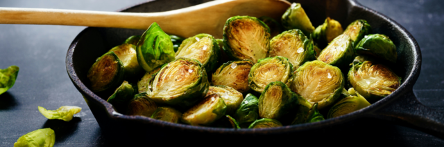 sauteed brussels sprouts in a cast iron skillet