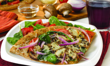 slice of pizza topped with peppers, onions and mushrooms