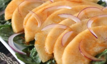 slices of cantaloupe with lime dressing and red onions
