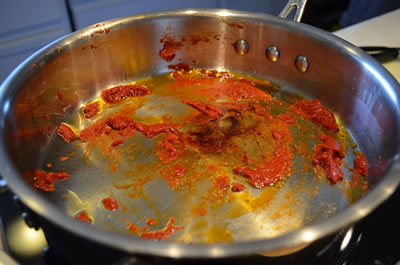 Over medium heat brown tomato paste, stirring frequently, until a brown, rust color is reached.