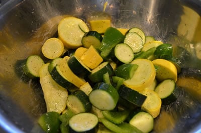 Add cut yellow squash, zucchini, and bell pepper to bowl. Toss to coat in oil. Sprinkle lightly with S&P