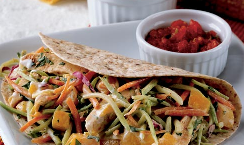 chicken tacos topped with broccoli slaw and peaches in a creamy dressing