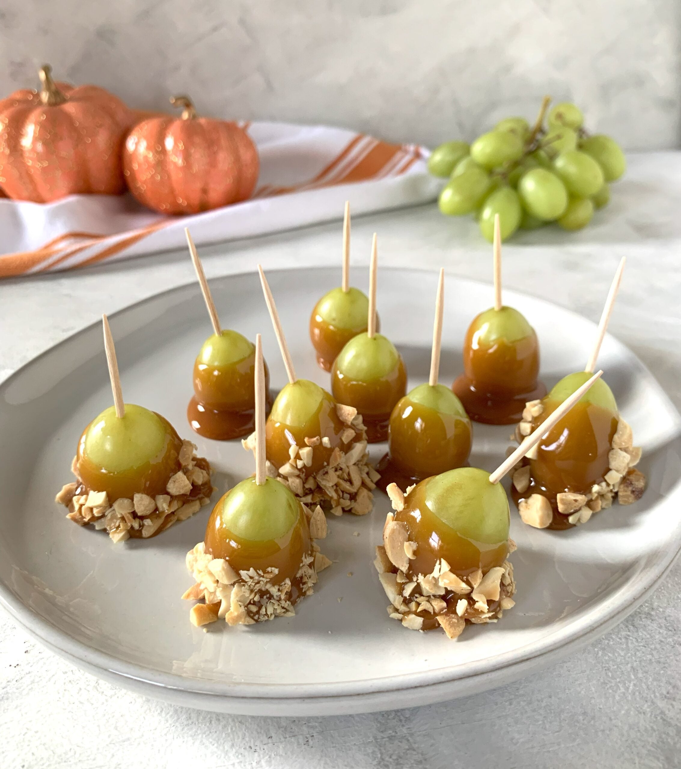green grapes dipped in caramel and crushed peanuts