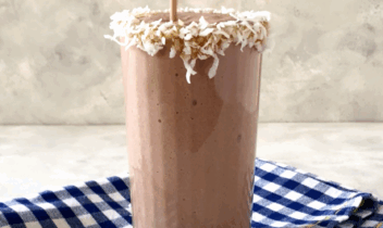 chocolate banana coconut smoothie being poured into a glass
