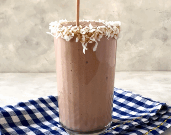 chocolate banana coconut smoothie being poured into a glass