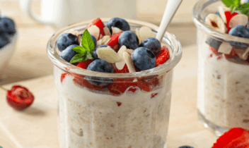 5 ONO listicle_Anna_Shepulova-Getty Images-Canva_masthead overnight oats topped with strawberries, blueberries and slivered almonds