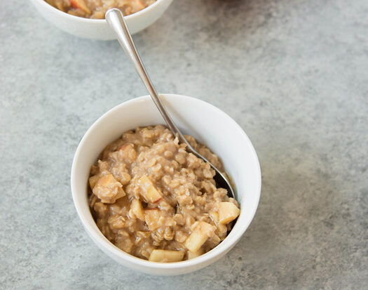 bowl of hot oatmeal with diced apples in it