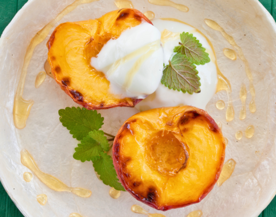 grilled peach halves topped with greek yogurt and drizzle of honey
