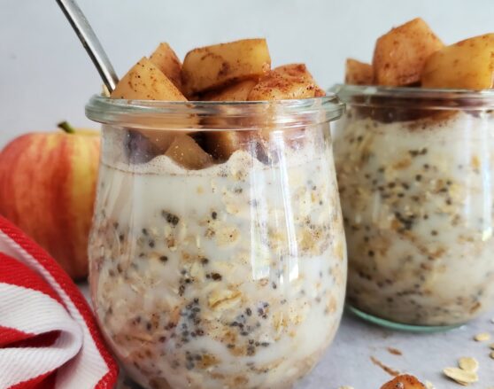 mason jar filled with overnight oats topped with cinnamon apples