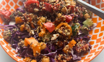 quinoa, bell peppers, cabbage in an orange bowl