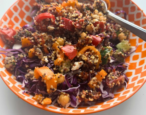 quinoa tabbouleh-edit quinoa, bell peppers, cabbage in an orange bowl